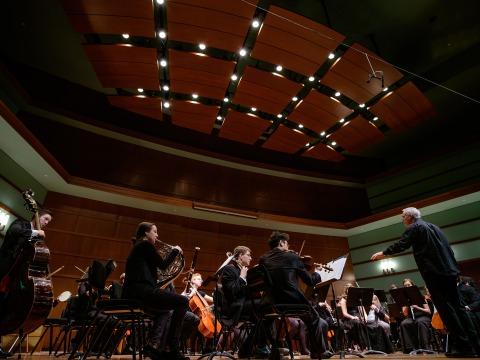 Eric McIntyre leads the symphony orchestra in a concert
